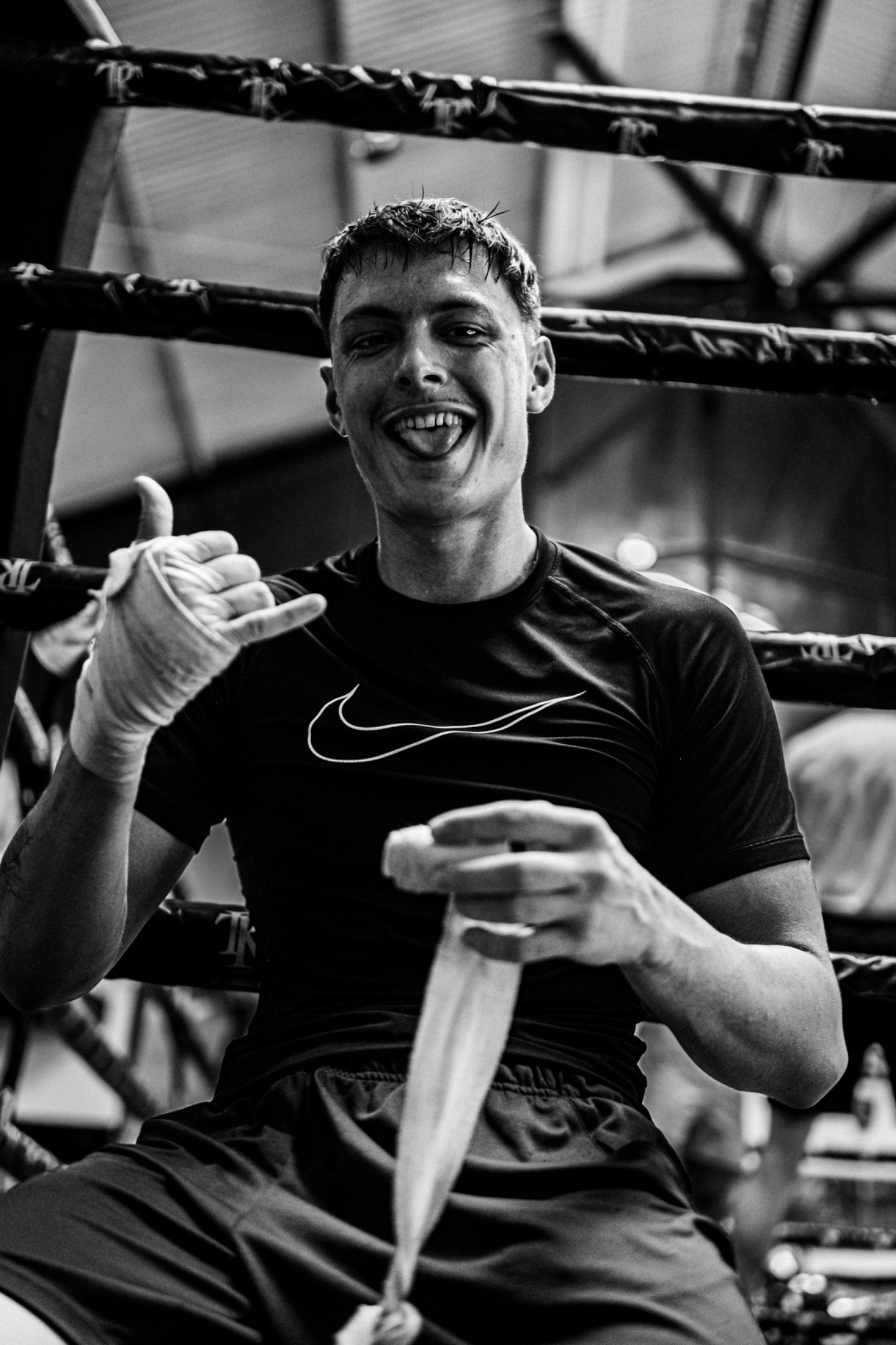 Andri Casutt smiling in a boxing ring while holding his hand wraps.