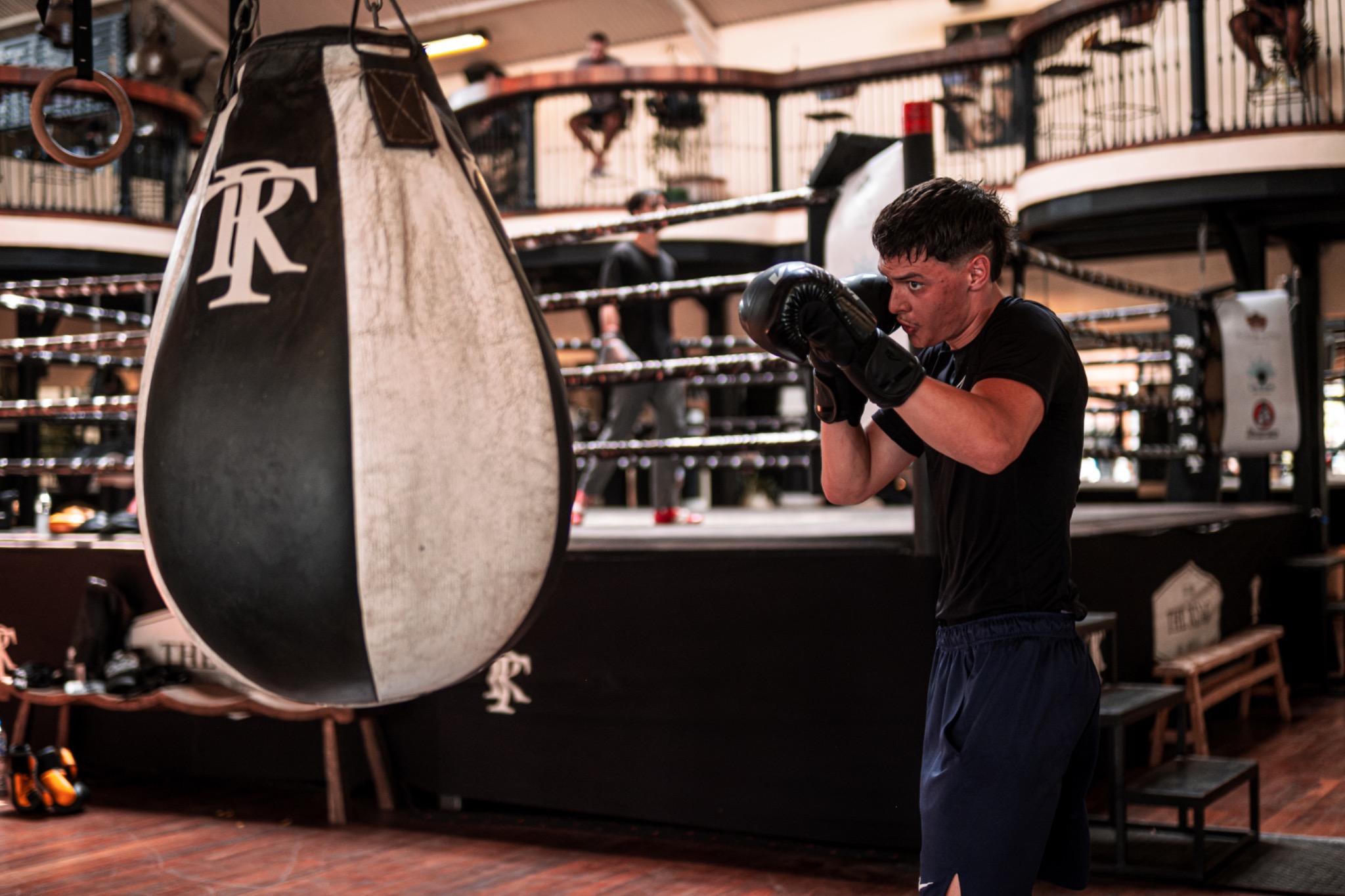 Andri Casutt training beside a suspended boxing bag inside The Ring Gym.