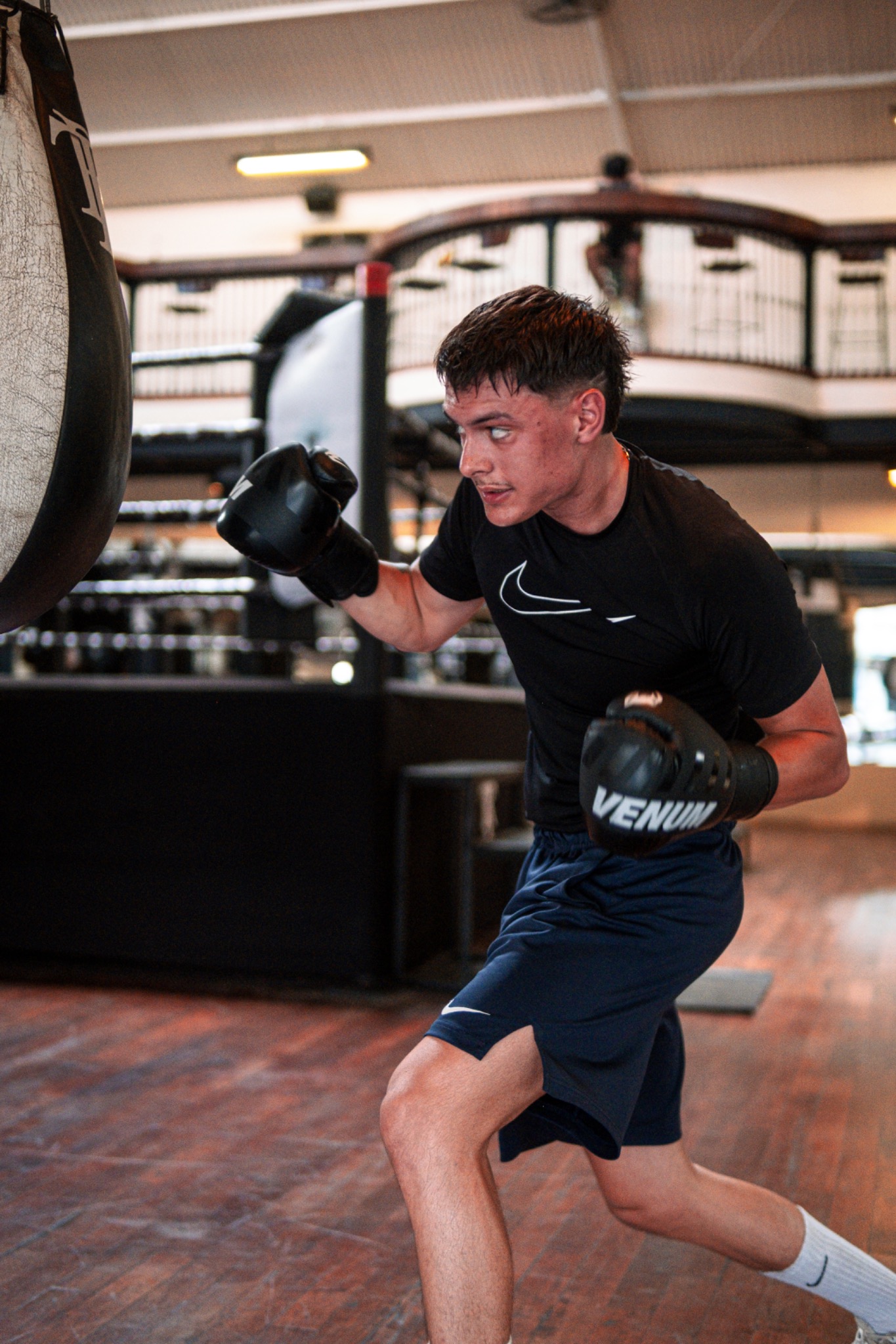 Color action photograph of Andri Casutt working the heavy bag.